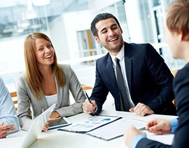 Four employees in a meeting.