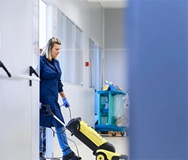 Woman cleaning the floor in a building.