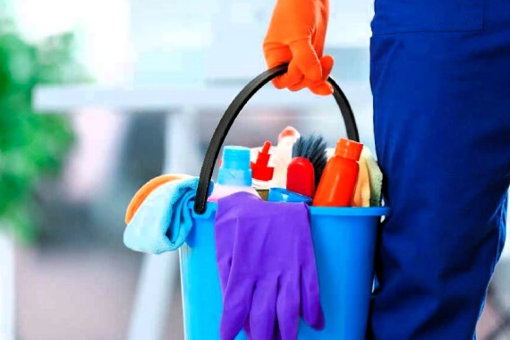 Cleaning lady with a bucket of cleaning supplies