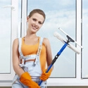 A woman cleaning a window.