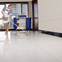 Woman cleaning the floor in a building.