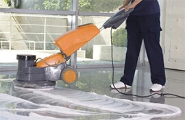 Woman cleaning the floor in a building.