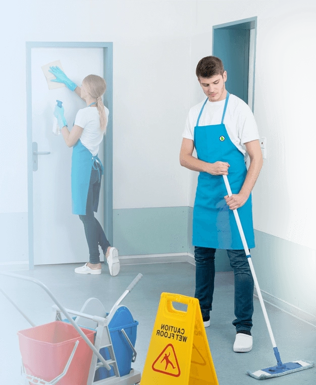 A man and a woman cleaning a room.